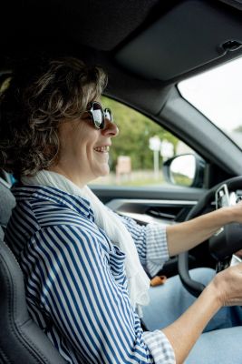 Professional guide driving guests in a comfortable vehicle through Normandy.