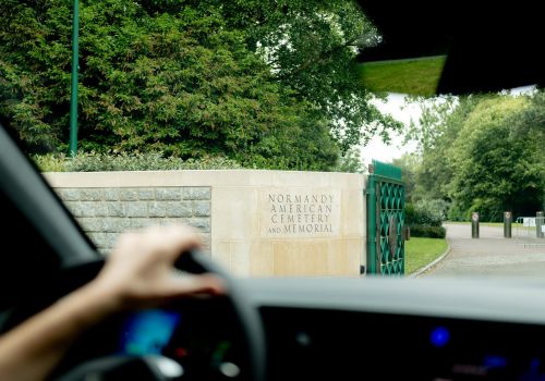 View from inside a car arriving at the Normandy American Cemetery for a guided tour.